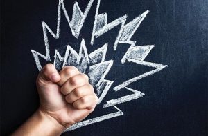 A balled up fist, surrounded by flames drawn on a chalkboard.